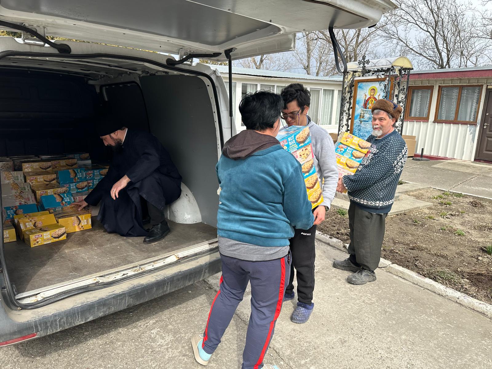 Members of the community carrying the boxes inside